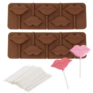 Silicone lip mold detail shot showing chocolate cavities, paper sticks and finished lollipops.