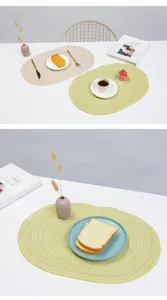 Detailed view of woven cotton placemat, oval table mat setting with tableware and decor.