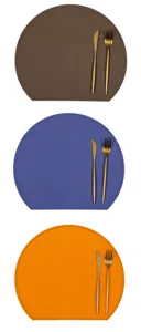 Silicone placemat detail view showing brown, blue and orange Nordic style table placemats with cutlery.
