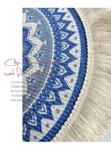 Nordic bohemian woven cotton placemat detail showing intricate blue geometric pattern and fringe.