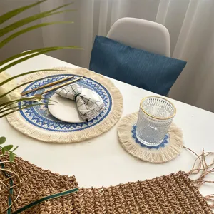 Nordic bohemian woven cotton placemat with blue pattern and tassel fringe for dining table decor.