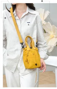 Yellow nylon mini bucket bag for women, casual crossbody phone bag with drawstring closure.