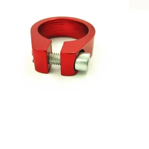 Detailed view of the red aluminum alloy bicycle seatpost clamp, featuring a sturdy single bolt.