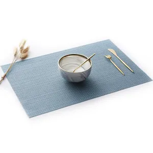 Blue PVC woven placemat heat insulating waterproof table mat for dining table decoration.