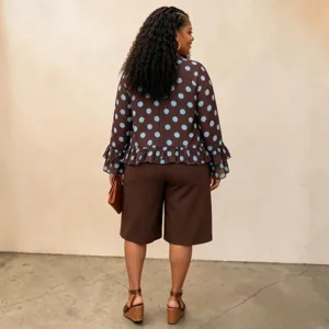 Detail shot of plus size polka dot long sleeve blouse and shorts set for women autumn fashion.