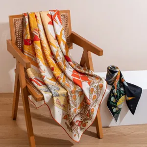 Detailed view of the luxury silk wool printed square scarf draped on a wooden chair.