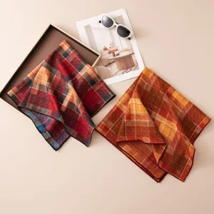 Detailed view of the luxury silk-wool plaid square scarf, featuring hand-rolled edges and texture.