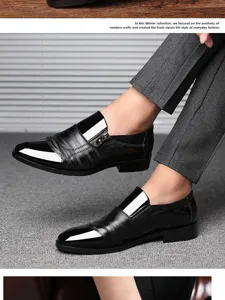 Detail view of men black dress leather shoes featuring a shiny cap-toe and side zipper accent.