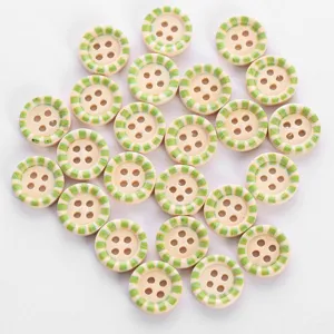 Close up of colorful printed wooden buttons with green stripes and four holes detail.