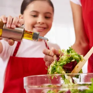 Stainless steel olive oil bottle pourer and wine stopper accessory for kitchen cooking and dining.