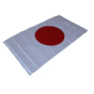 Detail view of the Japanese national flag showing white fabric, red circle, and metal grommet.