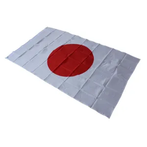 Detailed view of the Japan national flag, featuring crisp red sun on white fabric.