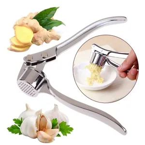 Detail view of manual zinc alloy garlic press showing crushing cavity and user action.
