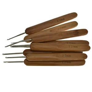 Carbonized bamboo handle metal crochet hook set for sweater knitting and DIY craft sewing projects.