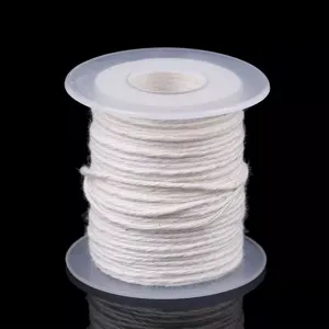 White cotton candle wick on a transparent plastic spool, ideal for DIY candle making.
