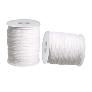Close-up detail of white cotton braided candle wick on spool for DIY candle making.