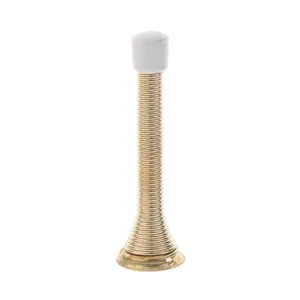 Detail view of a golden spring door stopper with white rubber tip for bedroom protection.