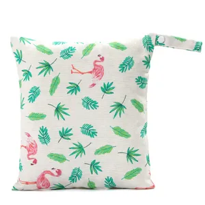 Portable baby diaper wet bag with cute flamingo and green leaf pattern, ideal for travel.