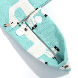 Close-up detail of baby hanging bag strap with snap button and cute animal print fabric.
