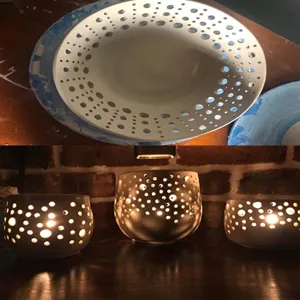 Handmade ceramic pottery with intricate hollowed round holes detail craft display piece.