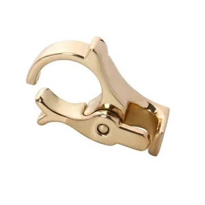 Detail view of gold metal finger cigarette holder ring, stylish smoke accessory for hands-free convenience.