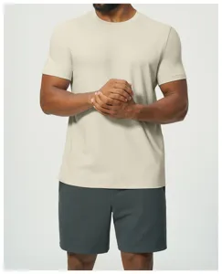 Close up view of mens beige short sleeve t-shirt and dark grey shorts detail showcase