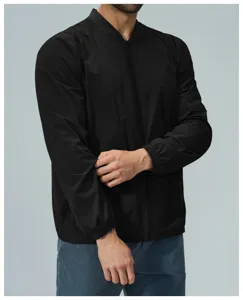 Detail view of men's black zip-up bomber jacket, featuring stand collar and elastic cuffs.