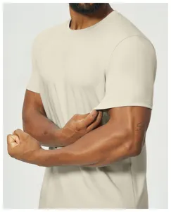 Men's casual beige short sleeve t-shirt close up showing fabric stretch and texture detail.