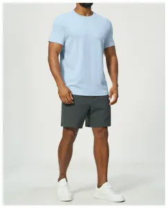 Detailed view of men's casual light blue short sleeve t-shirt and dark grey shorts outfit.
