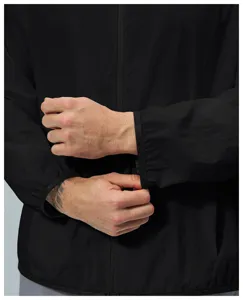 Close-up view of lightweight black windbreaker jacket sleeve and elastic cuff detail in high quality.