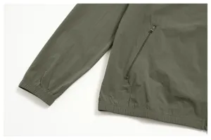 Men's autumn casual zipper jacket detail close-up showing olive green fabric and pocket.