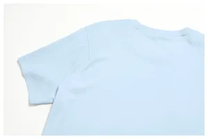 Light blue t-shirt detail showcasing shoulder raglan seam and soft breathable cotton fabric.