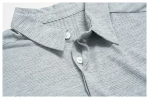 Detailed view of men's heather gray quick-dry golf polo shirt collar and buttons.