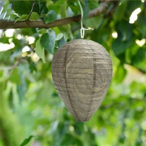 Hanging fake wasp nest lantern detail view, outdoor garden pest deterrent hanging decoration.
