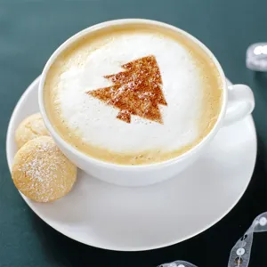 Close up view of a decorative coffee cup featuring a lovely Christmas tree foam art design.