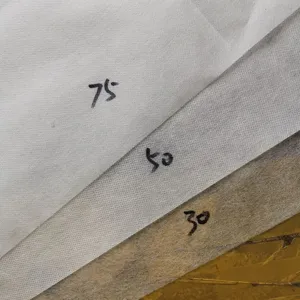 Non-woven plant cover fabric sample showing 75g 50g 30g thickness for winter frost protection.