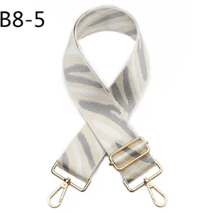 Adjustable wide replacement bag strap with zebra print and gold hardware for crossbody purses.