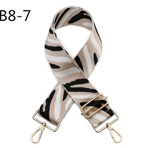Zebra pattern bag strap detail, adjustable replacement crossbody strap with gold metal hardware.