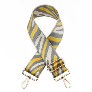 Adjustable replacement bag strap with yellow grey zebra print and gold hardware.