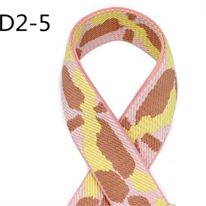 Detailed close-up of 5cm wide jacquard webbing strap in pink, yellow and brown camo pattern.