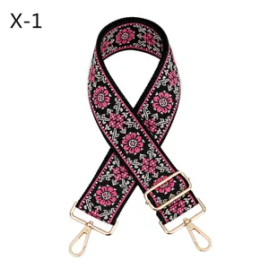Embroidered bag strap detail, ethnic floral pattern, wide replacement strap with gold hardware.