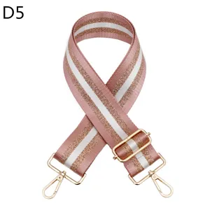 Detailed view of a pink glitter bag shoulder strap with gold hardware and adjustable buckle.