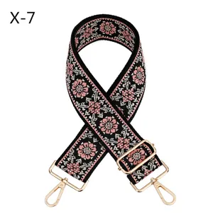 Ethnic embroidered bag strap replacement, adjustable black shoulder belt with pink floral pattern.