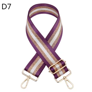 Detail shot of purple and white striped replacement bag strap with shiny gold thread and hardware.