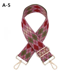 Wide embroidered bag strap replacement with argyle pattern and gold tone hardware.