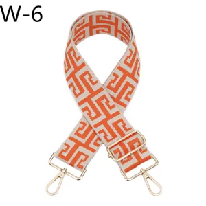 Adjustable replacement bag strap with chic geometric jacquard pattern and gold tone metal hardware.