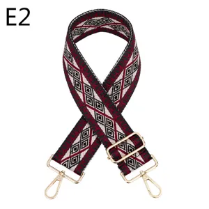 Close-up of ethnic geometric pattern bag strap with gold metal hardware and adjustable buckle.