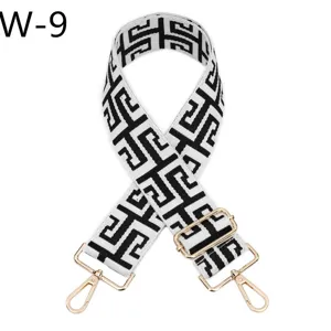 Black and white jacquard bag strap detail, adjustable length with gold tone metal hardware.