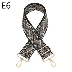 Woven bag strap detail showing ethnic geometric pattern and adjustable gold metal hardware.