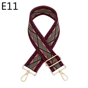 Close-up of ethnic woven bag strap, geometric pattern with gold tone adjustable metal hardware.